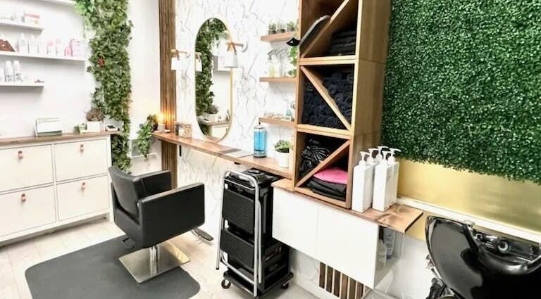 Elegant salon station at Calluna Hair, Calgary, Alberta, CA, featuring greenery and modern decor.