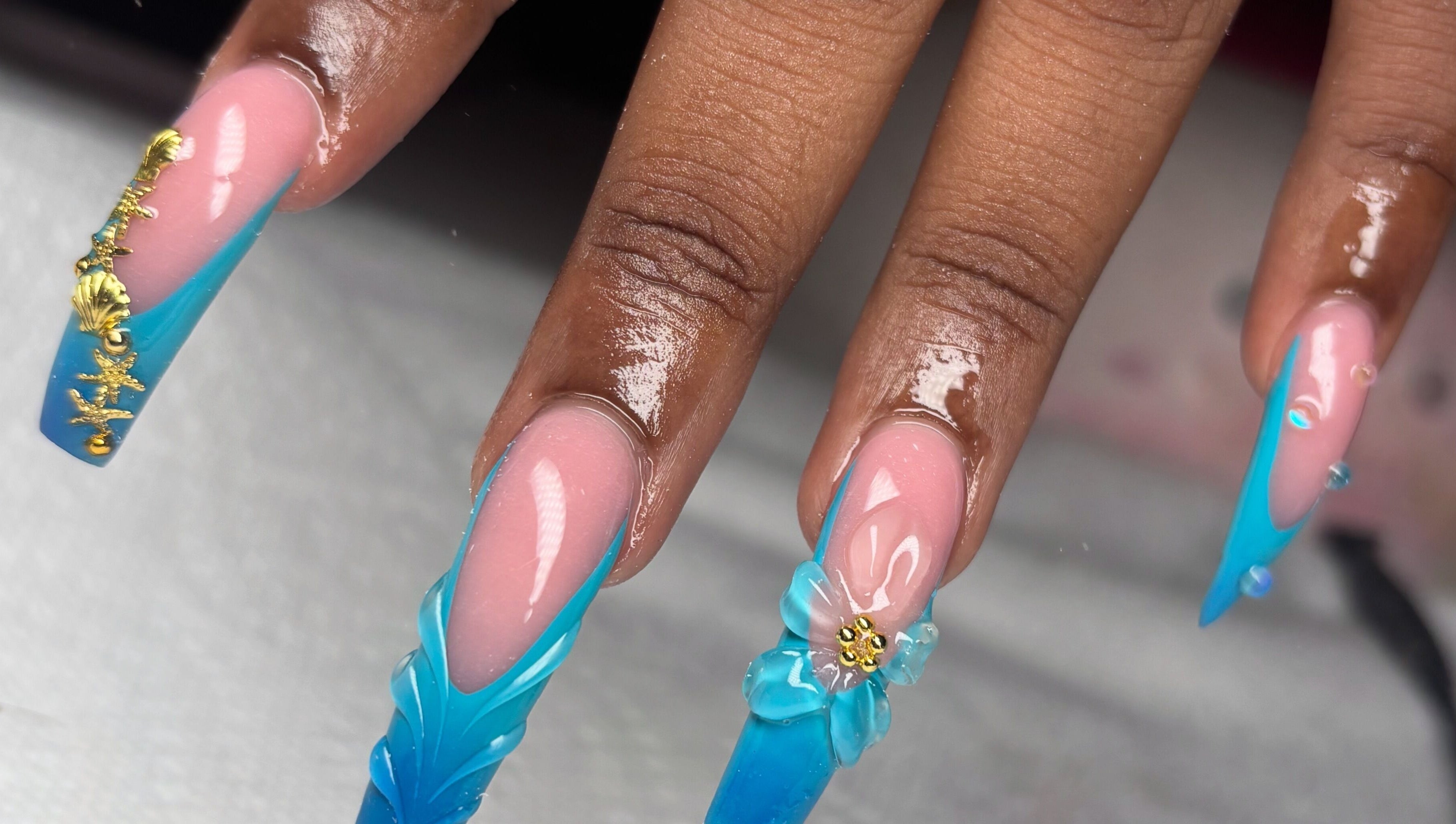 Stylish blue nail art by Pressed Nails, Bridgetown, Saint Michael, BB featuring intricate gold accents.