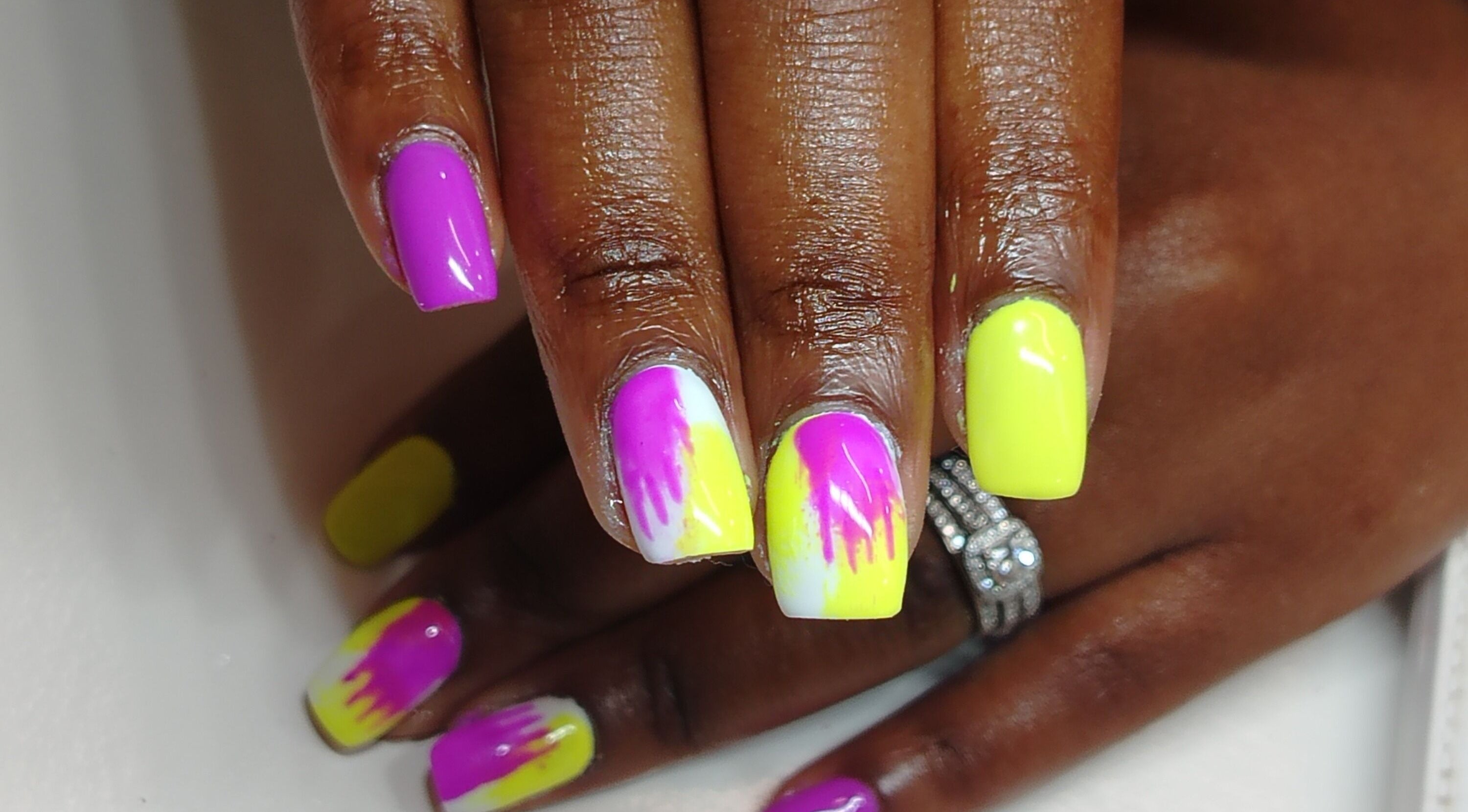 Stylish nail art with bright pink and yellow tones at Lavi Beauty Clinic, Pretoria, Gauteng, ZA.
