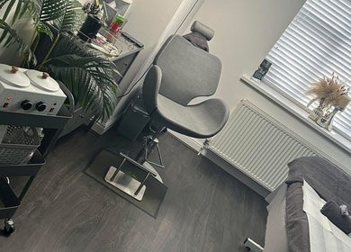 Elegant treatment room at Brow & Beauty Co., New Waltham, England, GB, featuring modern decor and soft lighting.