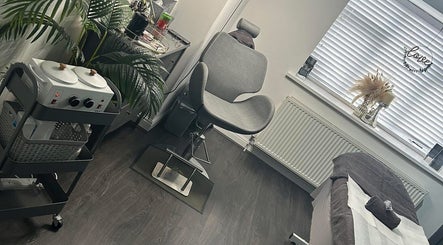 Elegant treatment room at Brow & Beauty Co., New Waltham, England, GB, featuring modern decor and soft lighting.