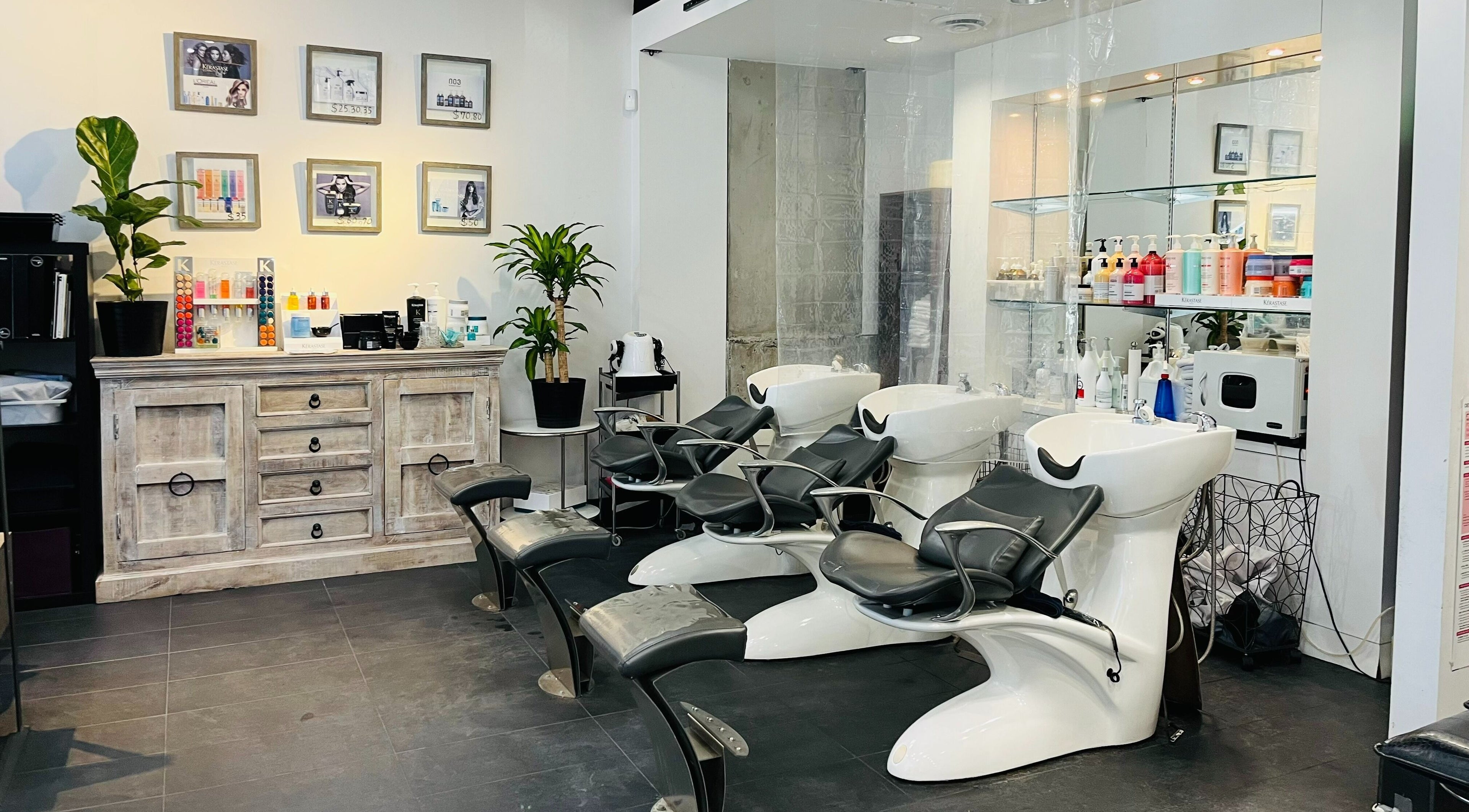 Air Hair Salon's sleek interior in Vancouver, British Columbia, CA with modern wash stations and decor.