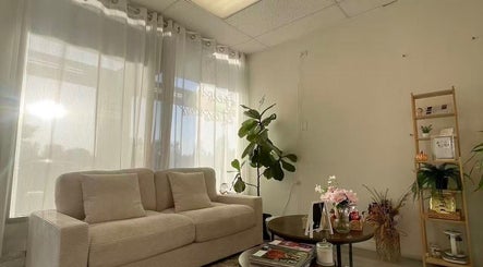 Cozy lounge with soft seating at Magiclash Brea, Brea, California, US, illuminated by gentle sunlight.