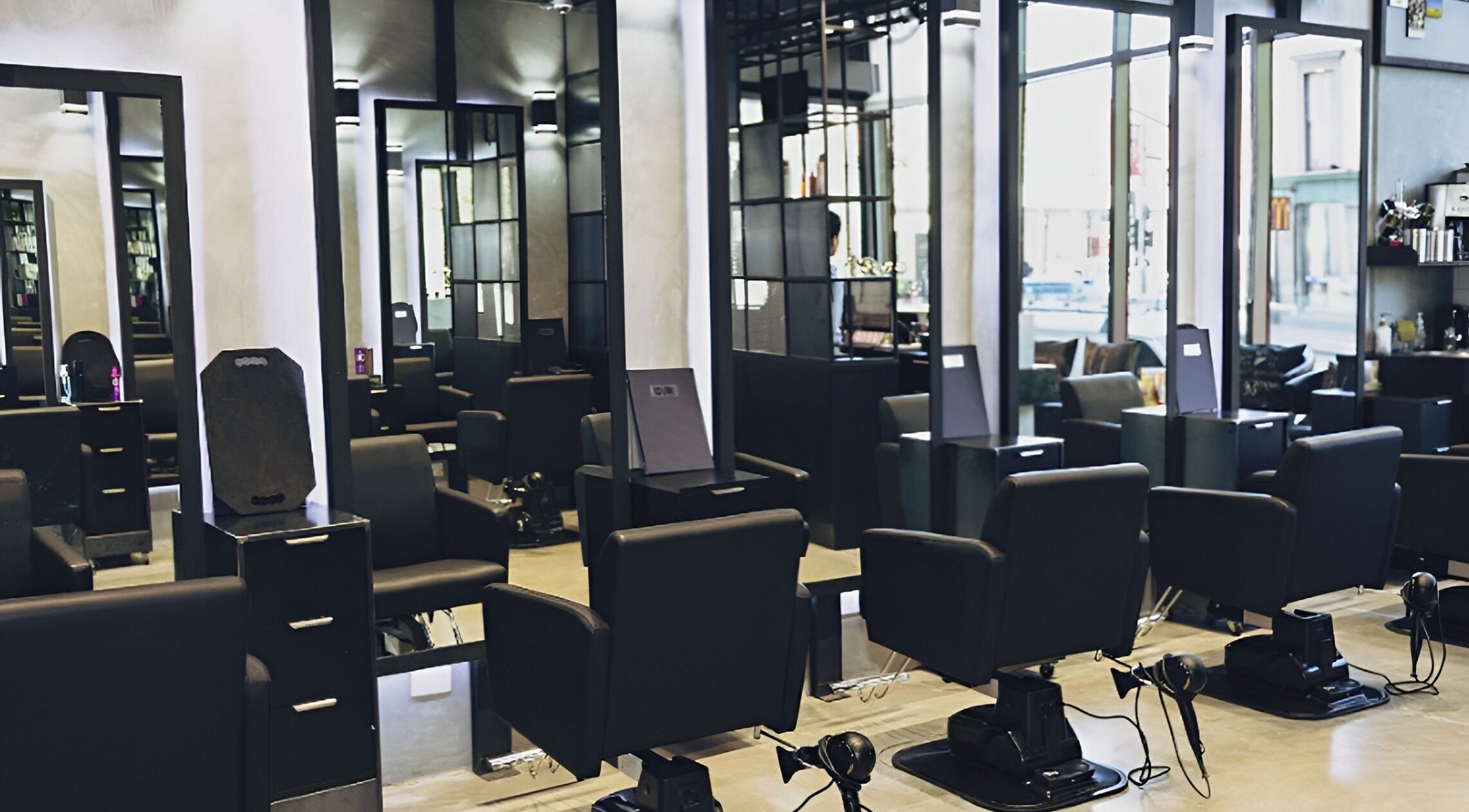 Stylish salon setup at D2M Hair Salon City in Melbourne, Victoria, AU with modern black chairs and mirrors.