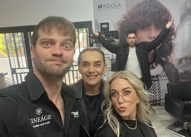 Energetic team at The Hair Scene, Pretoria, Gauteng, ZA, posing inside the stylish salon.