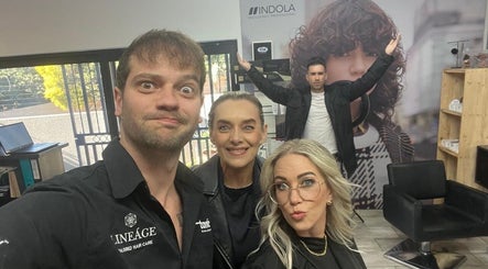 Energetic team at The Hair Scene, Pretoria, Gauteng, ZA, posing inside the stylish salon.