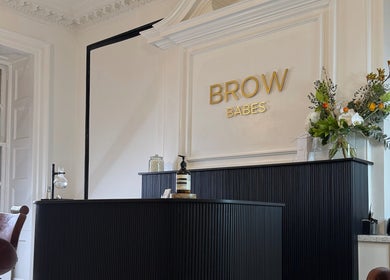 Reception area of Brow Babes - BrowZ by Harry in Truro, England, GB; stylish decor and floral arrangement.