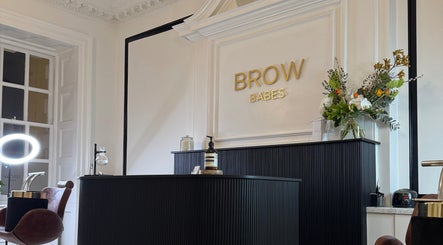 Reception area of Brow Babes - BrowZ by Harry in Truro, England, GB; stylish decor and floral arrangement.