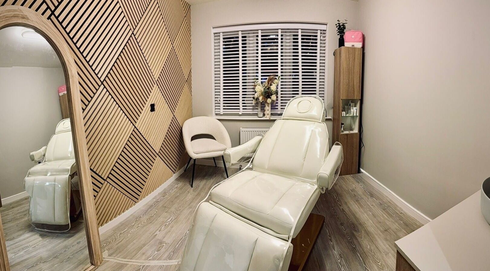 Luxury treatment room at The Hideaway Clinic in Princes Risborough, England, featuring a modern chair and elegant decor.