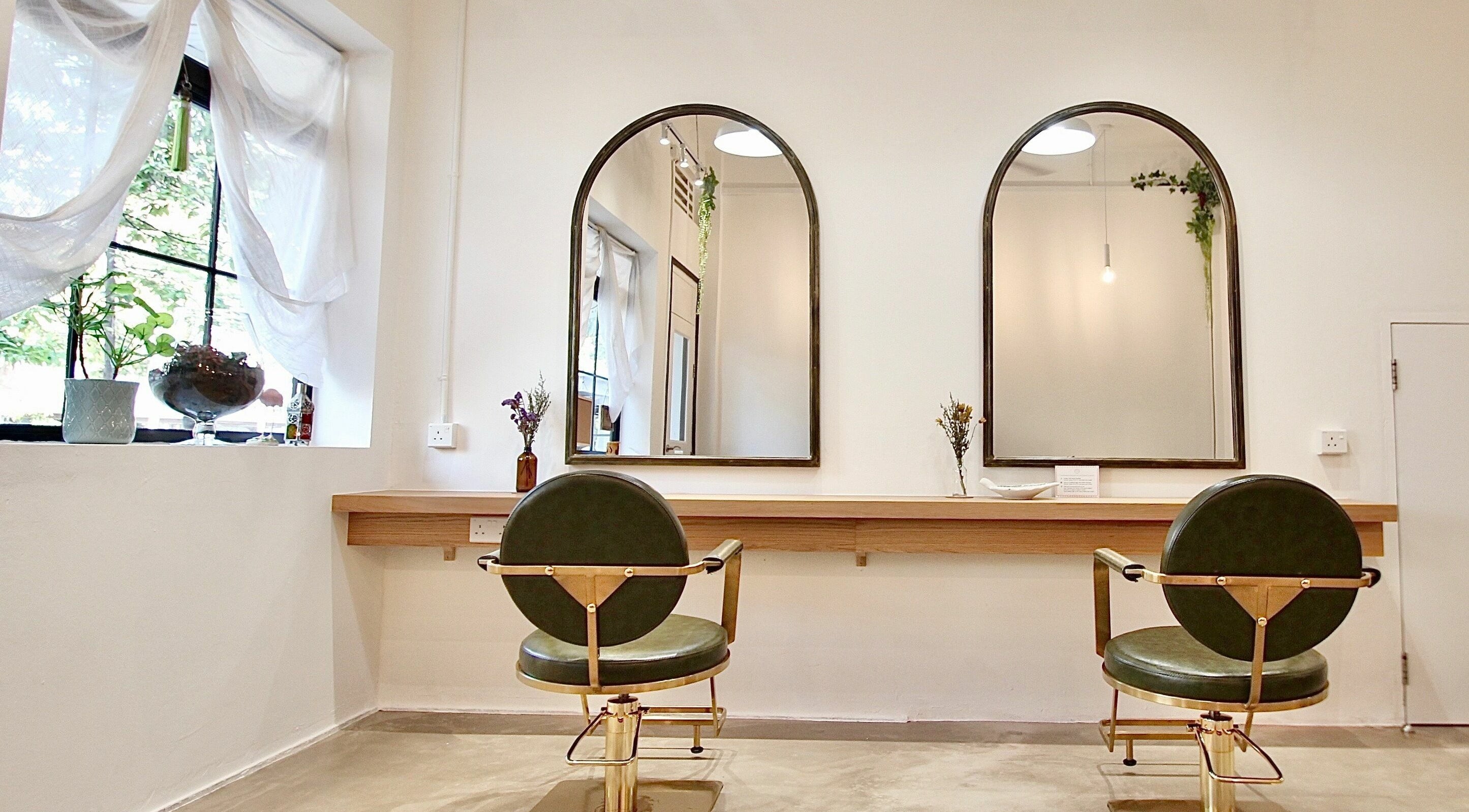 Hairstudio Flamingo - Tiong Bahru's elegant salon setup in Singapore, Singapore, SG with stylish mirrors and chairs.