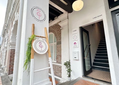 Entrance of Eyelash Studio Flamingo - Tanjong Pagar, Singapore, SG, featuring a stylish sign and greenery.
