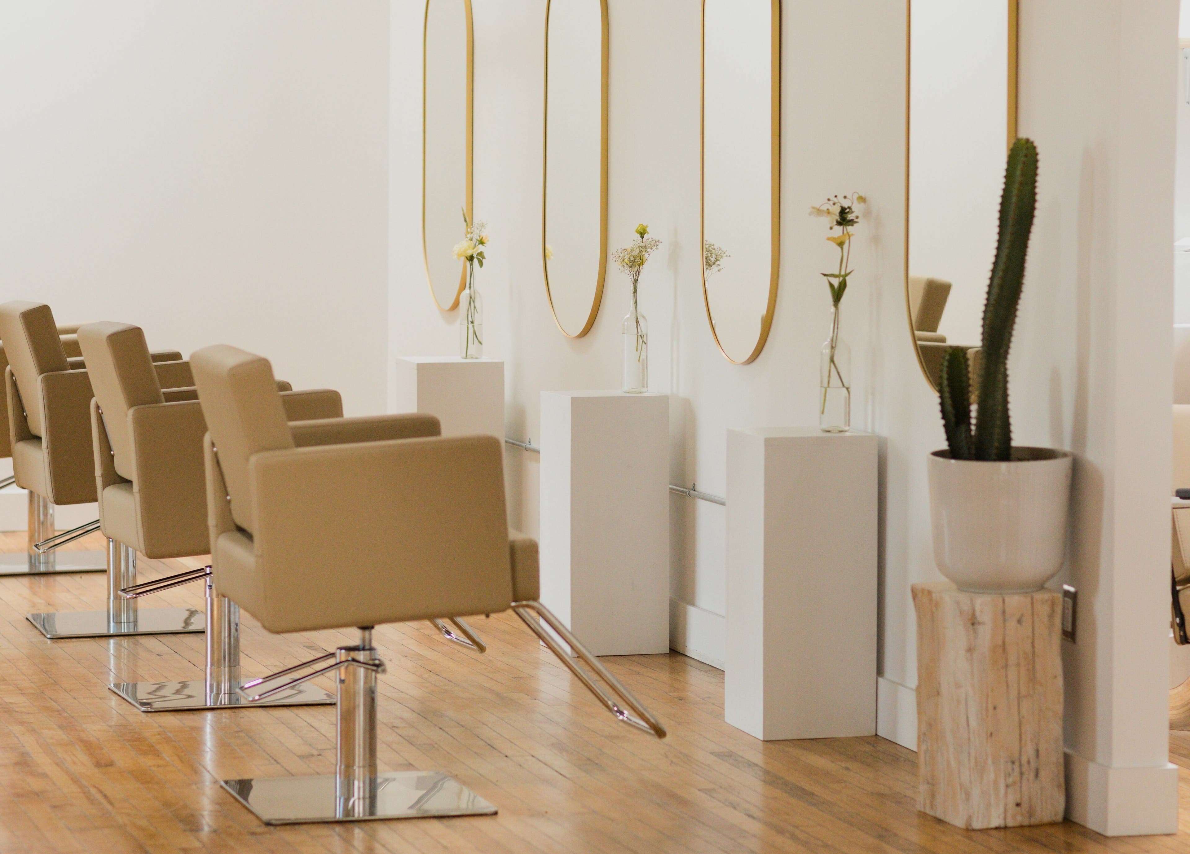 Elegant salon chairs and mirrors at THIC Studio, Toronto, Ontario, CA, creating a stylish beauty environment.