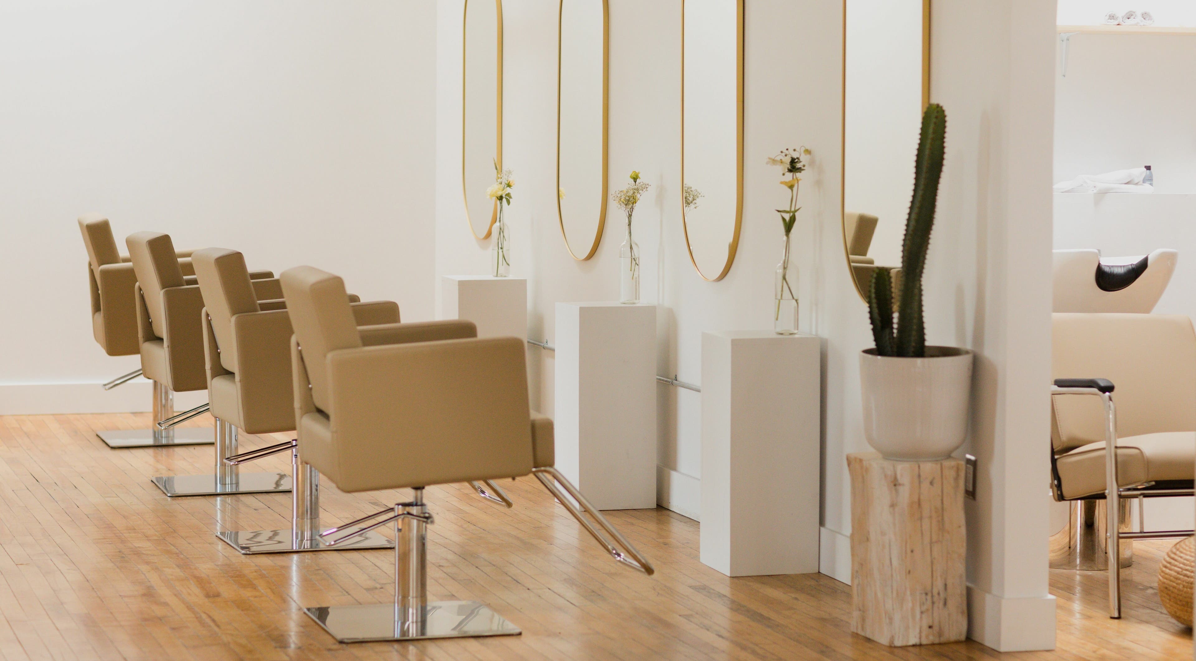 Elegant salon chairs and mirrors at THIC Studio, Toronto, Ontario, CA, creating a stylish beauty environment.