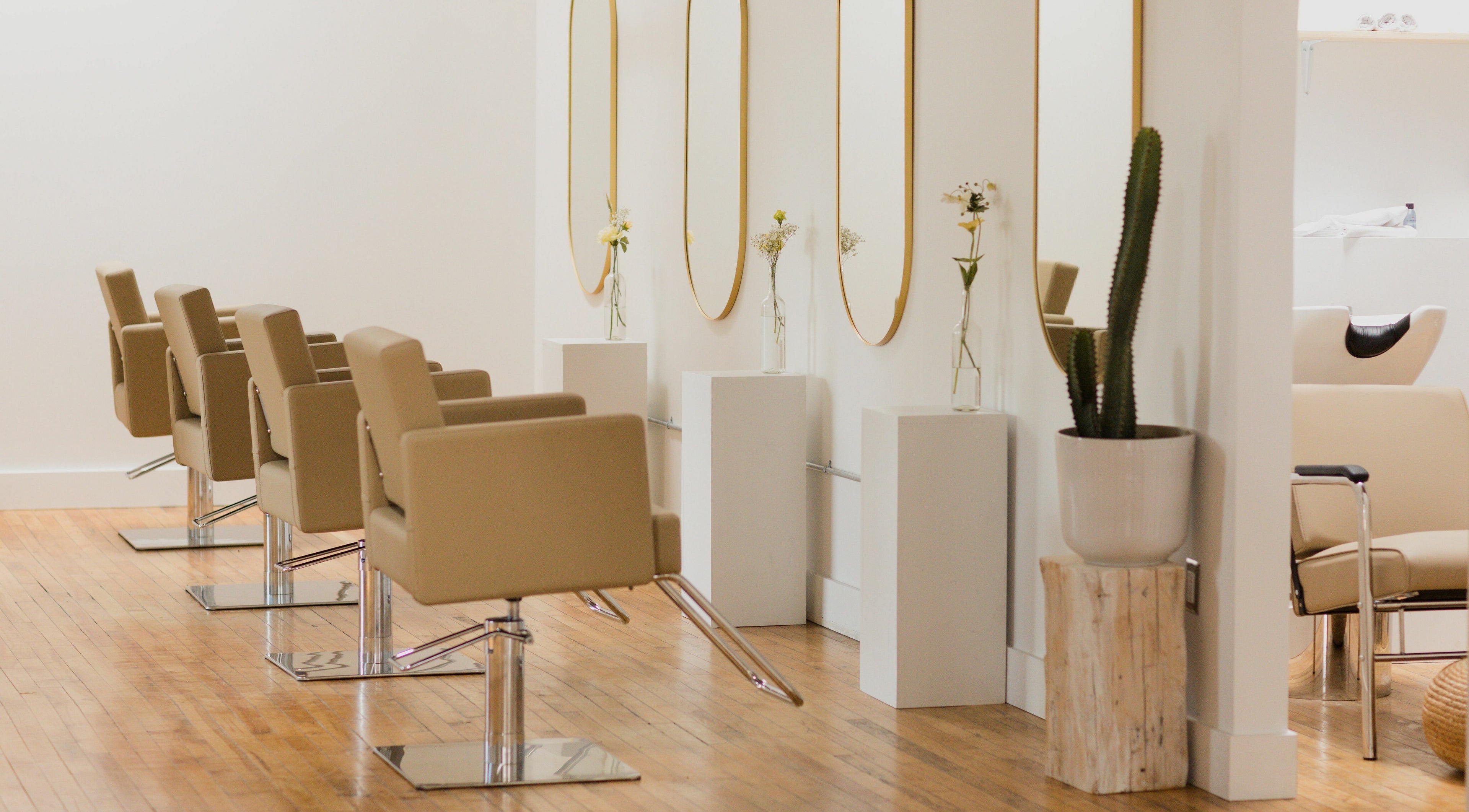 Elegant salon chairs and mirrors at THIC Studio, Toronto, Ontario, CA, creating a stylish beauty environment.