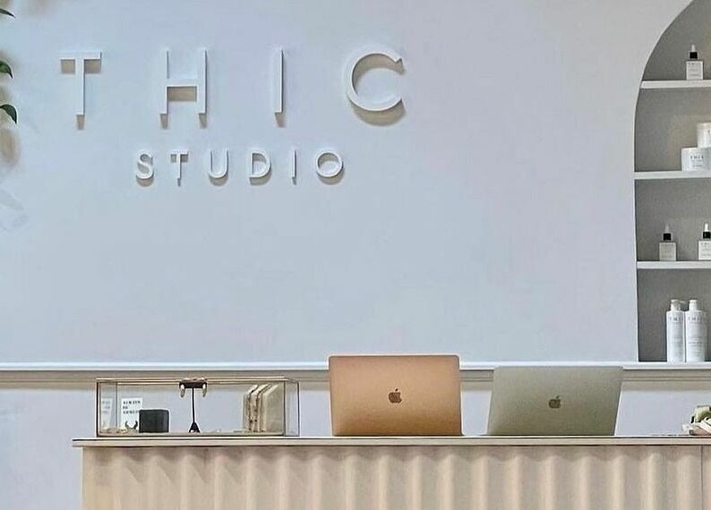 Reception desk at THIC Studio, a beauty venue in Toronto, Ontario, CA with minimalist decor.