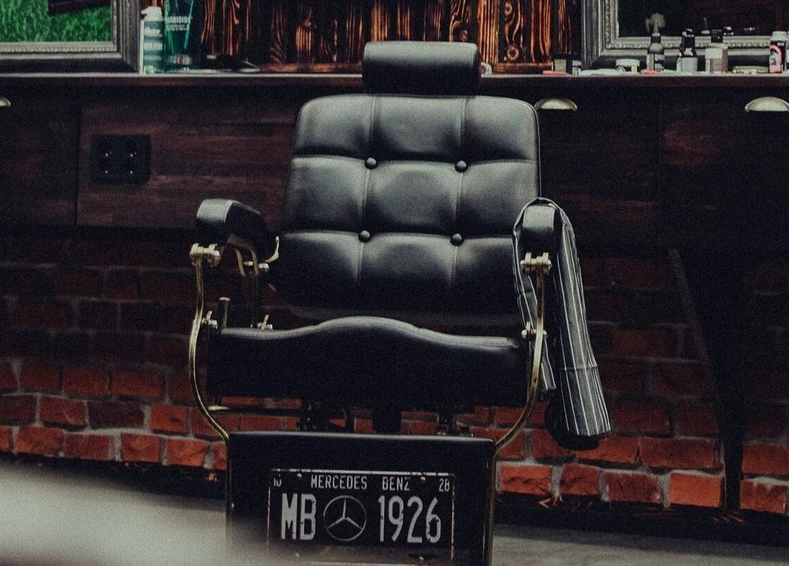Elegant black barber chair at Alligator Barbers, Oslo, Oslo, NO, showcasing a classic grooming atmosphere.