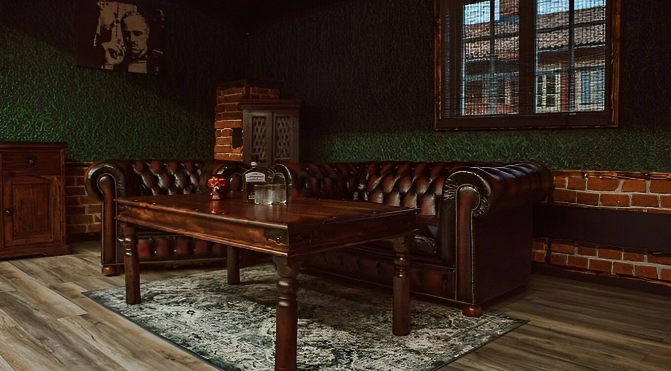 Cozy vintage lounge at Alligator Barbers, Oslo, Oslo, NO, featuring leather sofas and rustic decor.
