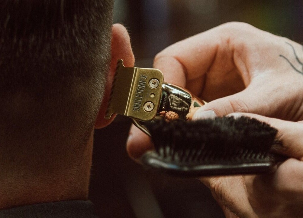 Close-up of hair clipper in action at Alligator Barbers, Oslo, Oslo, NO. Precision grooming captured.