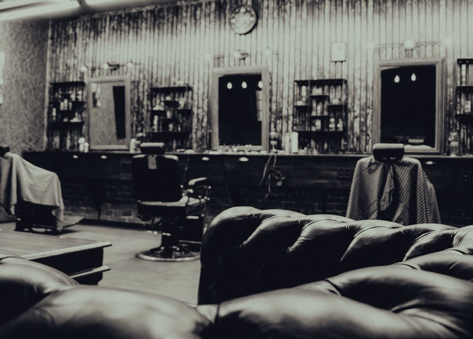 Chic vintage interior of Alligator Barbers, Oslo, Oslo, NO, showcasing classic barber chairs and decor.