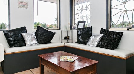 Stylish waiting area at Eye on Beauty, Bundall, Queensland, AU with black and silver cushions.