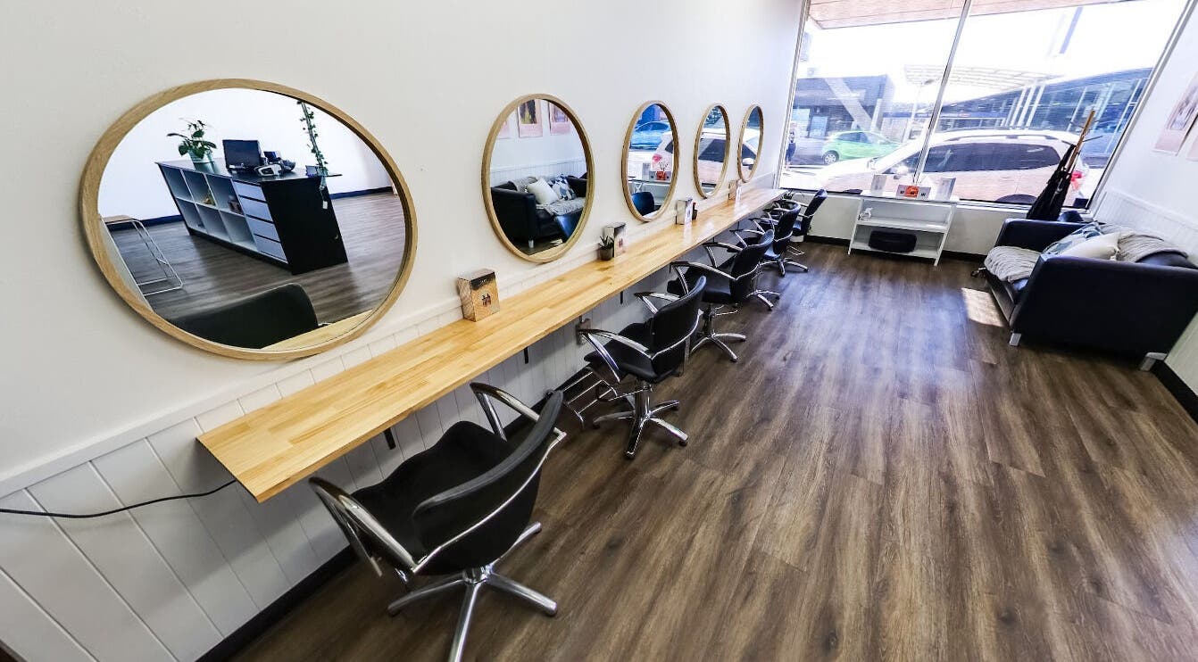 Interior of Evolve Hair Styles in Upper Burnie, Tasmania, AU with stylish mirrors and salon chairs.