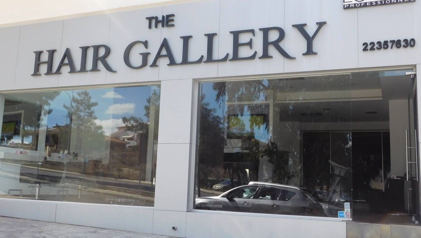 Exterior of The Hair Gallery by Yiota Morfi, Lakatamia, Nicosia, CY showcasing modern glass facade.