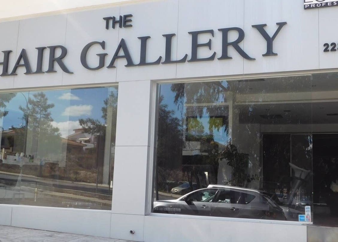 Exterior of The Hair Gallery by Yiota Morfi, Lakatamia, Nicosia, CY showcasing modern glass facade.