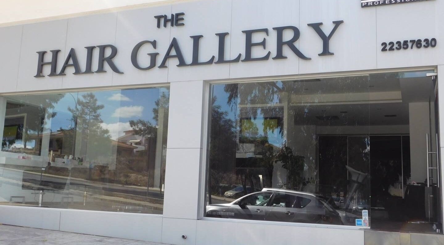 Exterior of The Hair Gallery by Yiota Morfi, Lakatamia, Nicosia, CY showcasing modern glass facade.