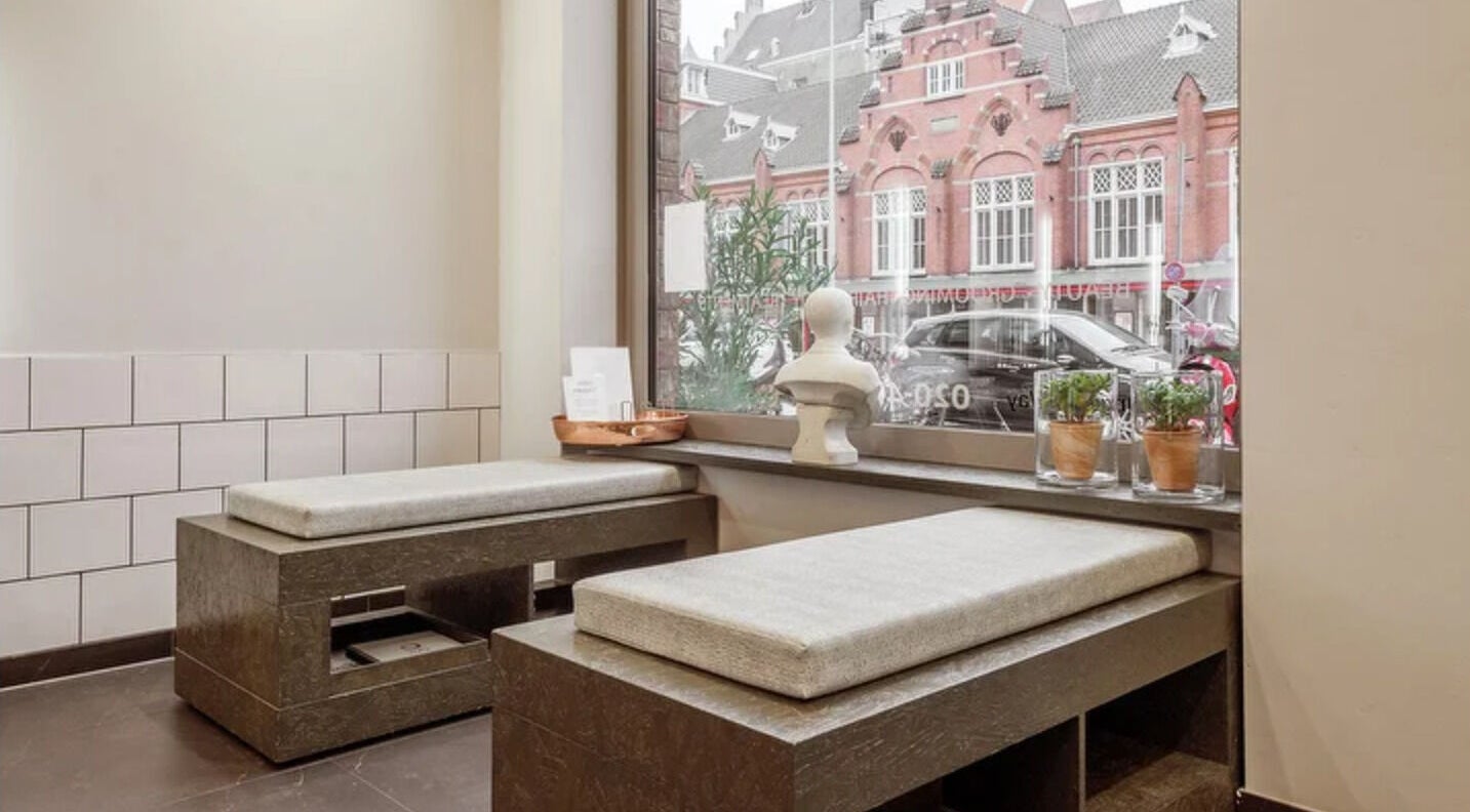 Cozy seating by window at Vanina Inner Beauty, Amsterdam, Noord-Holland, NL, perfect for relaxation and reflection.