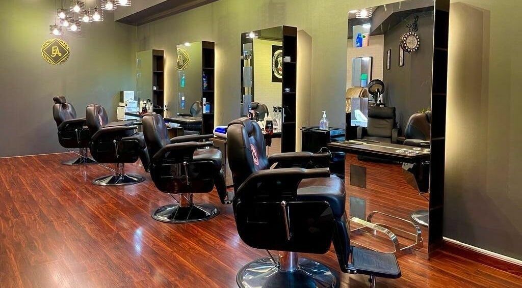 Sophisticated interior of Estilo Arts Barbershop in Dubai, AE, featuring stylish leather barber chairs.