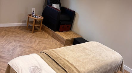 Relaxing massage room at Unwind Health and Beauty, Portsmouth, England, GB. Features comfortable massage chair.