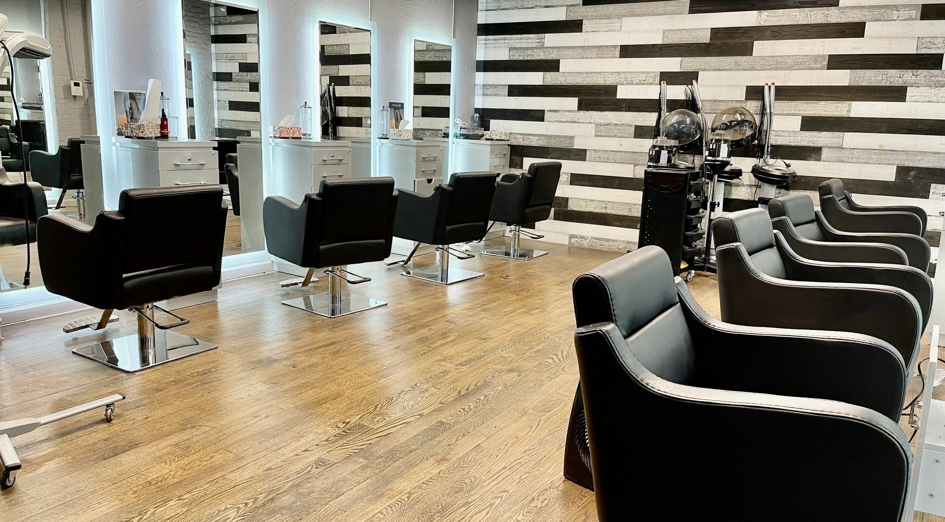 Modern salon chairs at Toto Hair, New York, New York, US, with sleek mirrors and stylish decor.