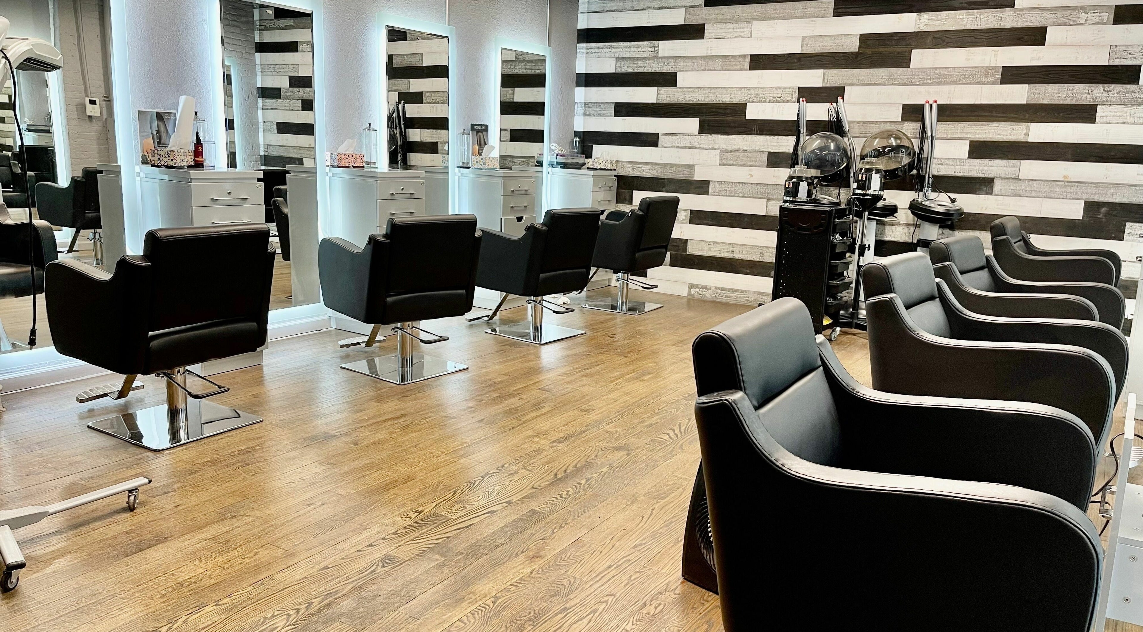 Modern salon chairs at Toto Hair, New York, New York, US, with sleek mirrors and stylish decor.