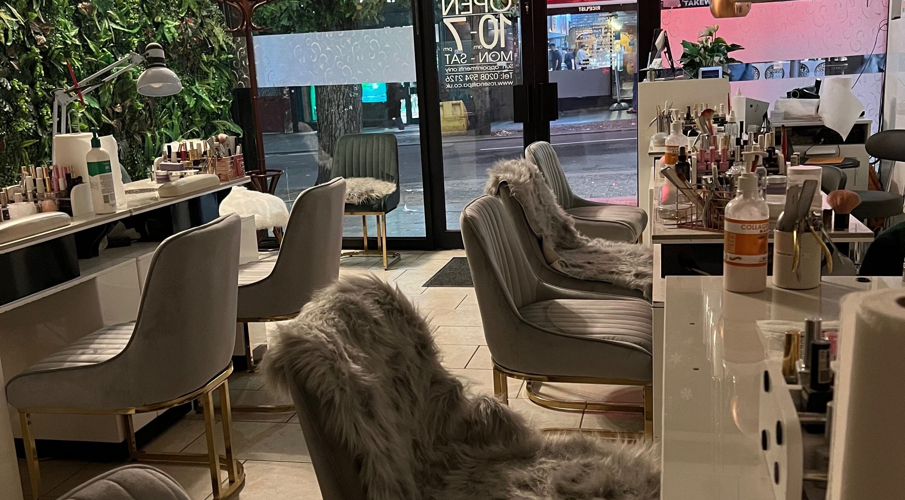 Stylish interior of Rose Nails, Barking, England, GB with plush chairs and manicure stations.