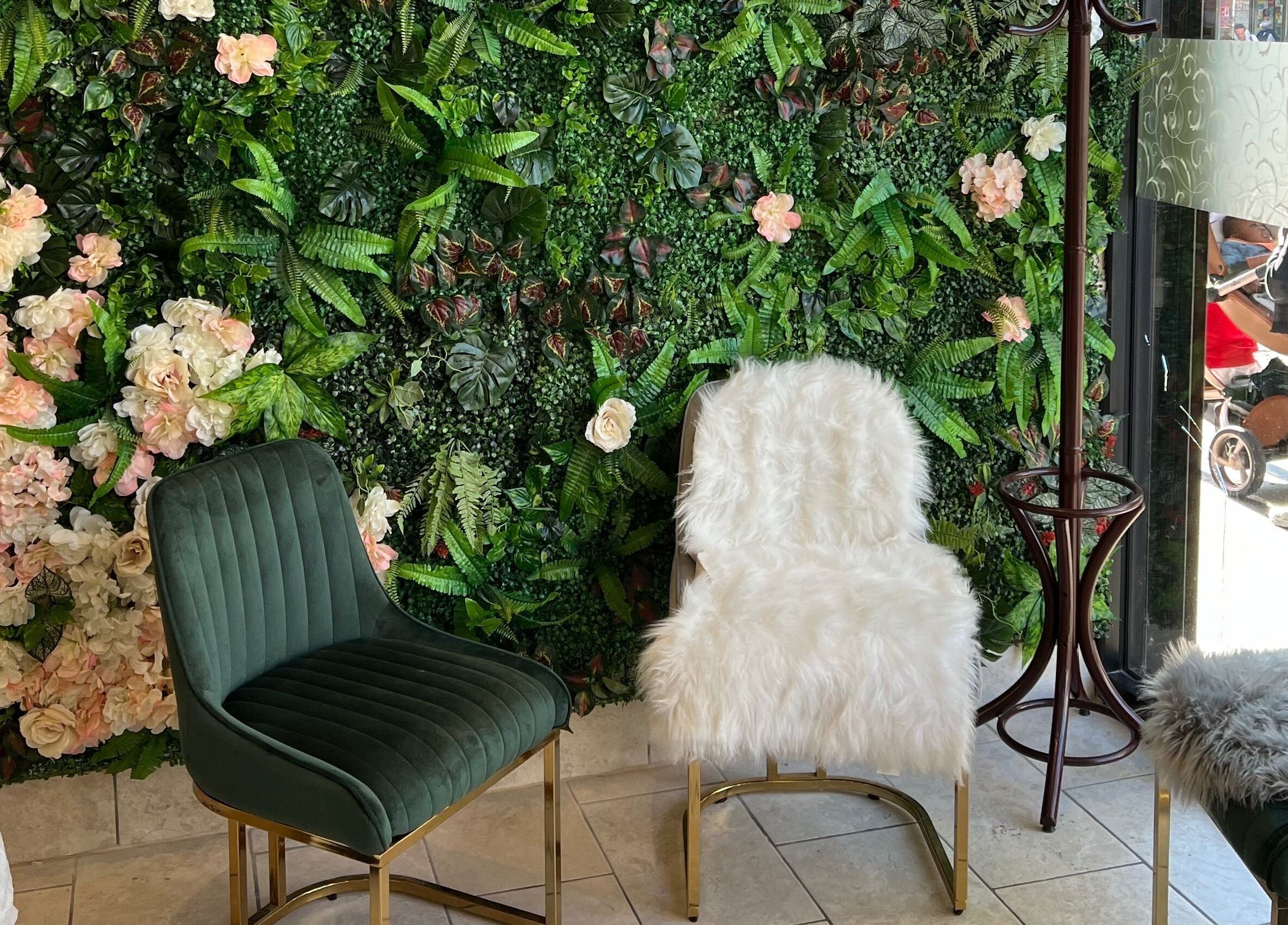 Elegant seating with floral wall at Rose Nails, Barking, England, GB offering a serene waiting area.