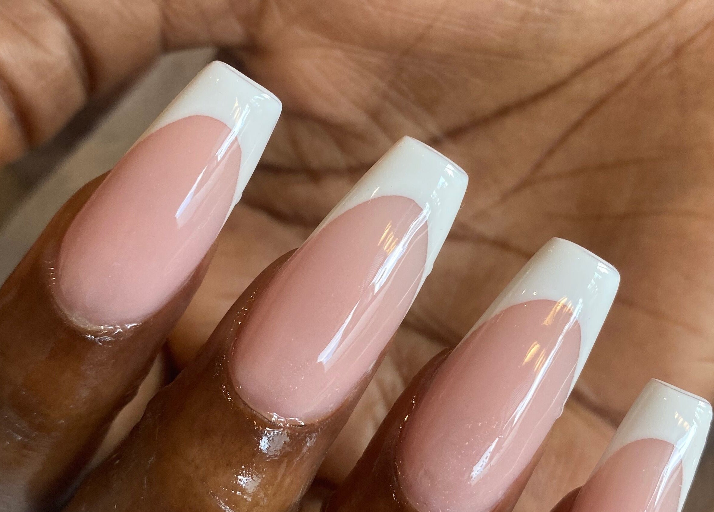 Elegant French manicure by Rose Nails in Barking, England, GB showcasing glossy, pink and white nail design.
