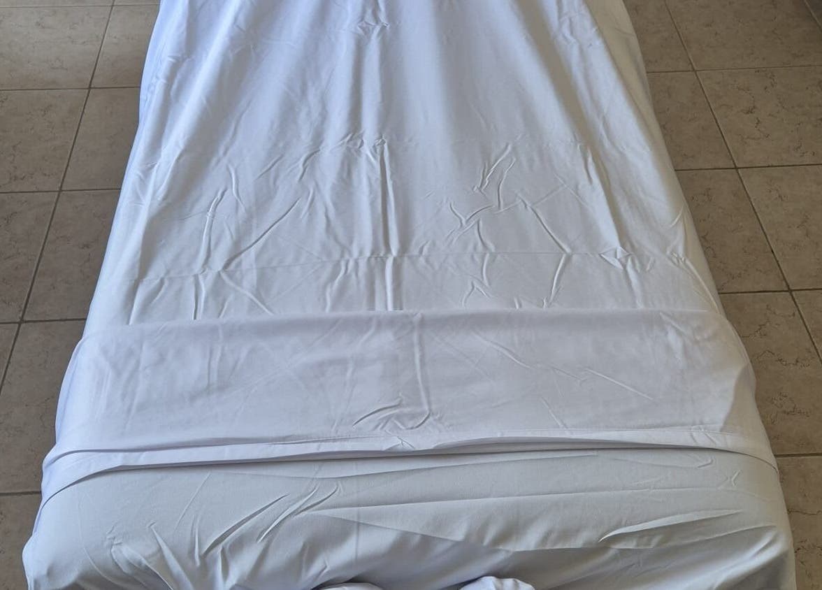 Relaxing massage bed at Passion Touches Spa in Bridgetown, Saint Michael, BB, featuring clean white linens.