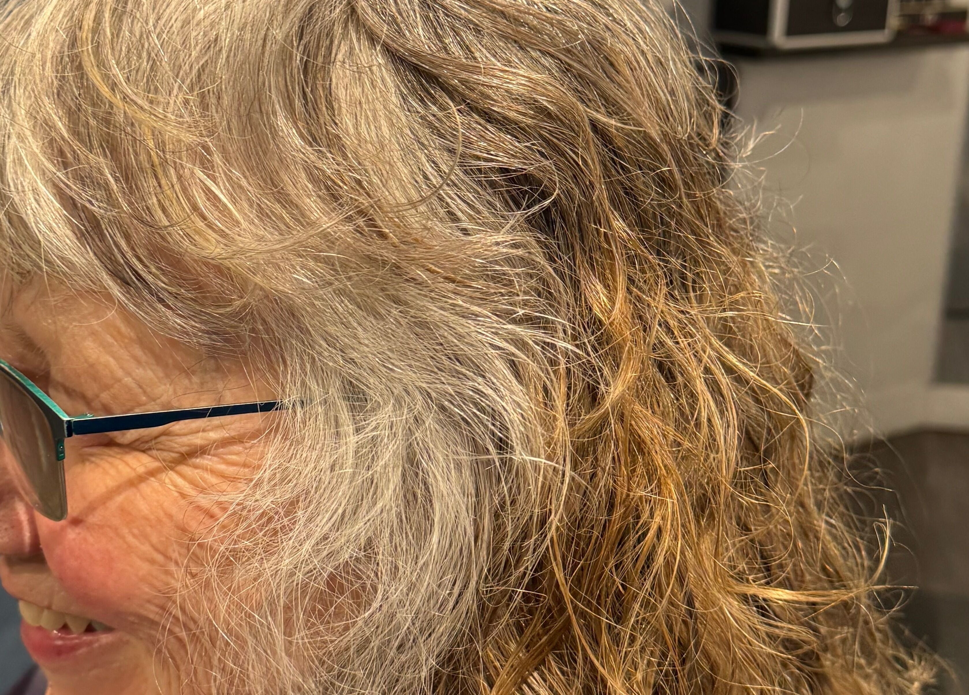 Happy client with styled wavy hair at Creative Look, Ruwis 83 Sherbrook Street, Winnipeg, Manitoba, CA.