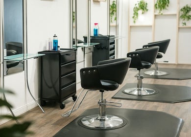Chic styling chairs at Salon X, Taos, New Mexico, US, featuring modern design and lush greenery.