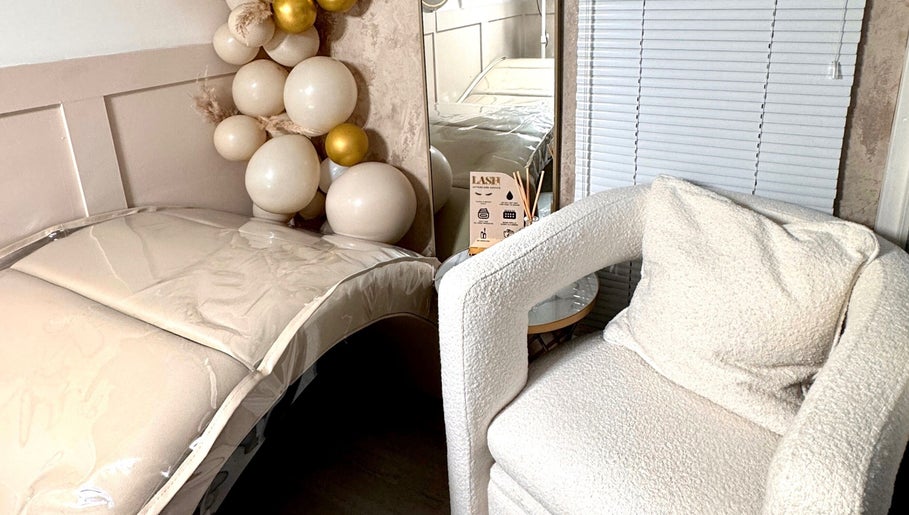 Relaxing treatment room at Beauty by Chloe, Dundee, Scotland, GB with plush chair and decorative balloons.