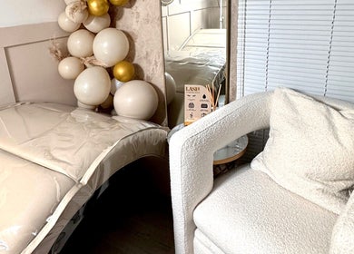 Relaxing treatment room at Beauty by Chloe, Dundee, Scotland, GB with plush chair and decorative balloons.