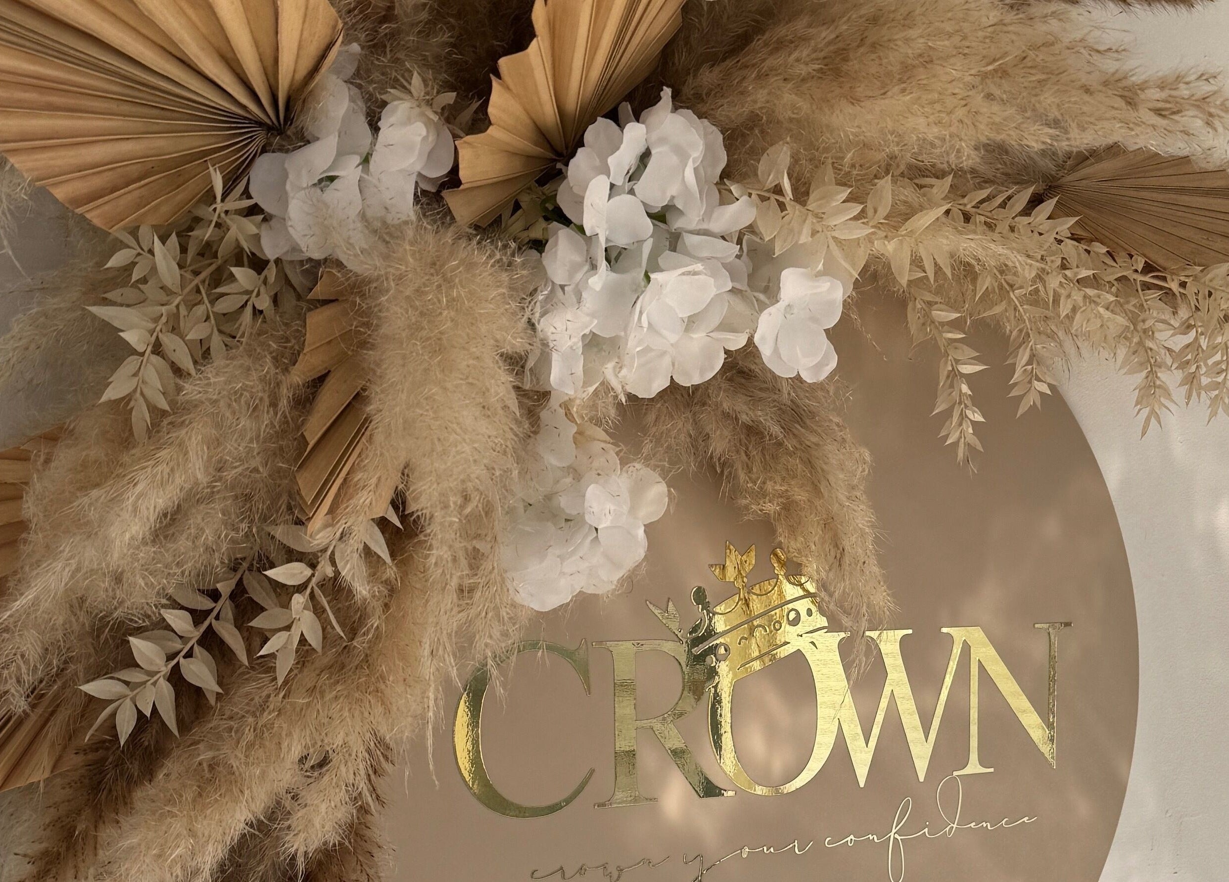 Dried foliage and white flowers with Crown By Chloe logo in Dundee, Scotland, GB.
