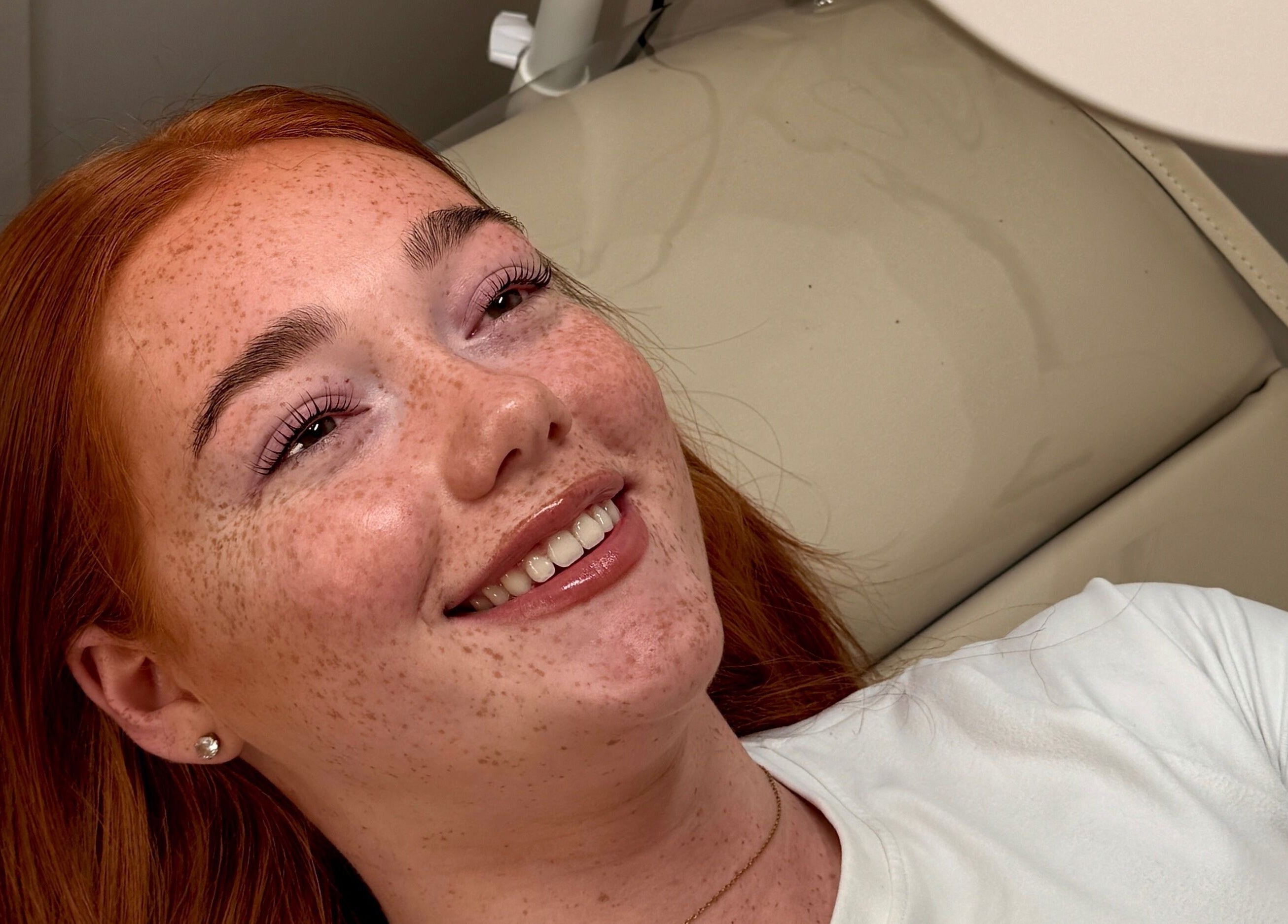 Client with radiant smile at Crown By Chloe in Dundee, Scotland, GB. Beauty and relaxation in serene setting.