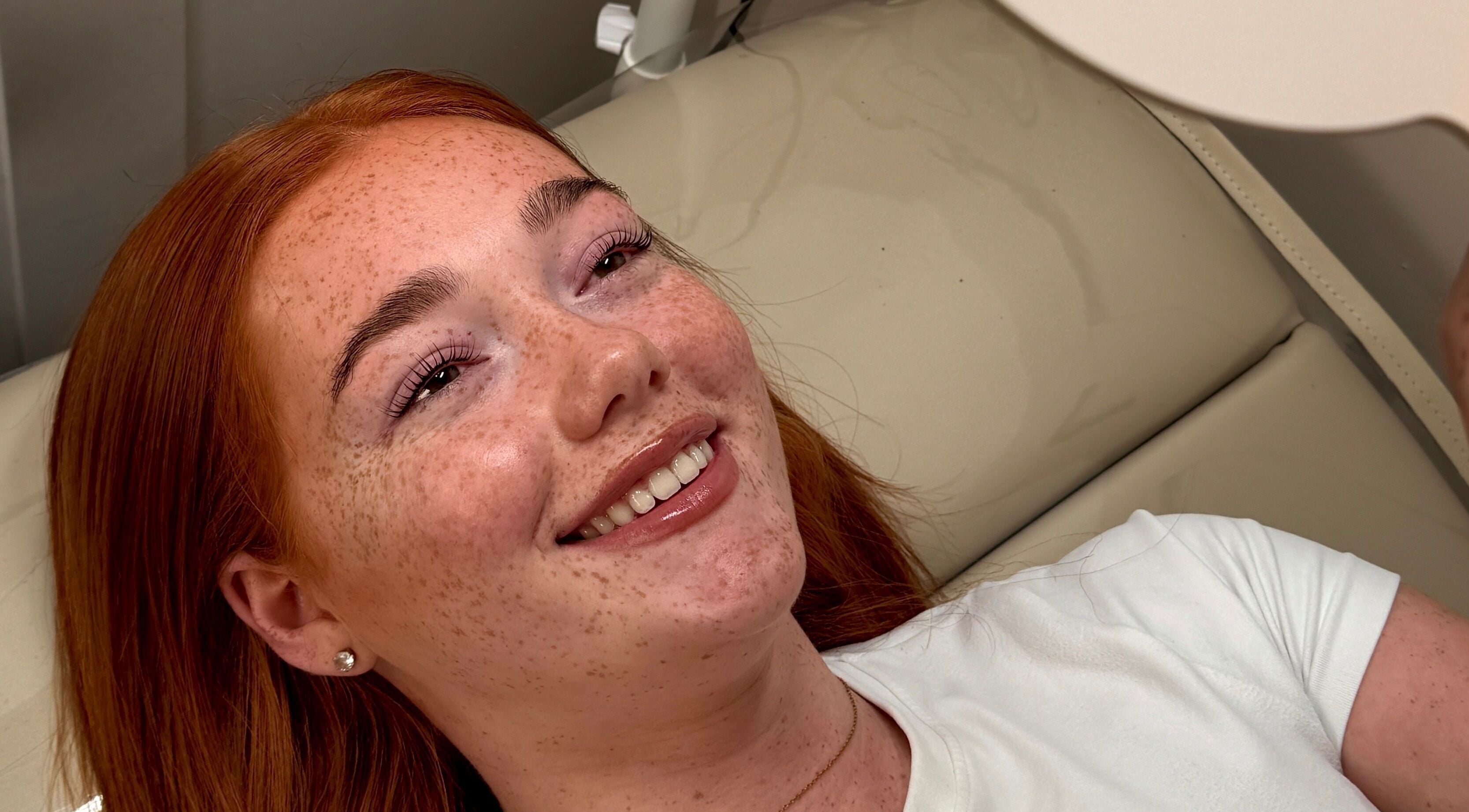 Client with radiant smile at Crown By Chloe in Dundee, Scotland, GB. Beauty and relaxation in serene setting.