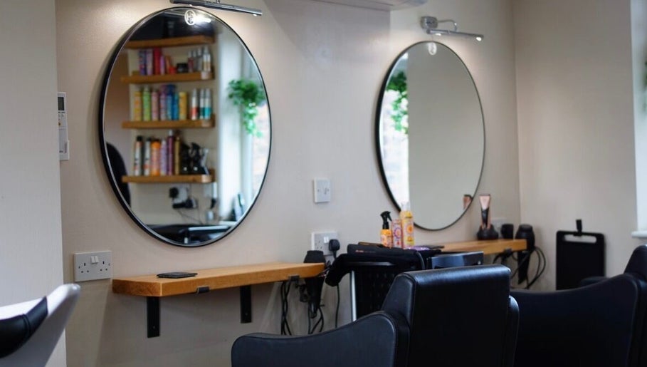 Modern styling stations at Head Quarters Hair and Beauty Salon, Thorngumbald, England, GB, with circular mirrors.