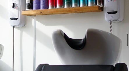 Wash station with hair products at Head Quarters Hair and Beauty Salon in Thorngumbald, England, GB.