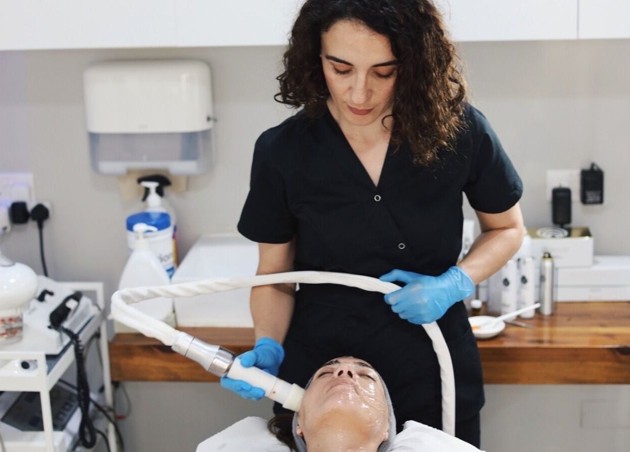 Aesthetician performing facial treatment at Xuefei Salon, Birkirkara, MT.