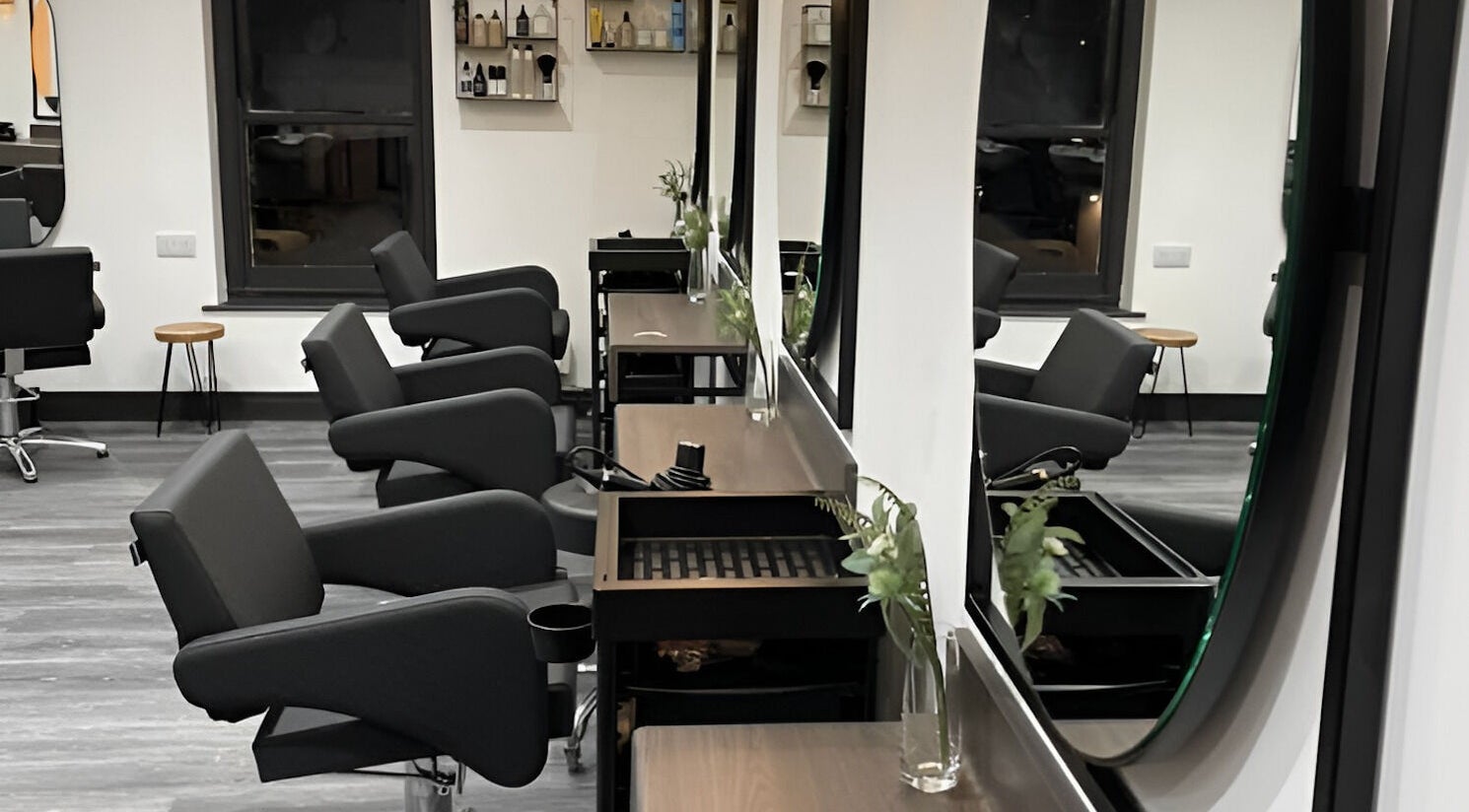 Sleek interior of Sage Hair Collective Abbie White, Liskeard, England, GB, featuring stylish salon chairs and mirrors.