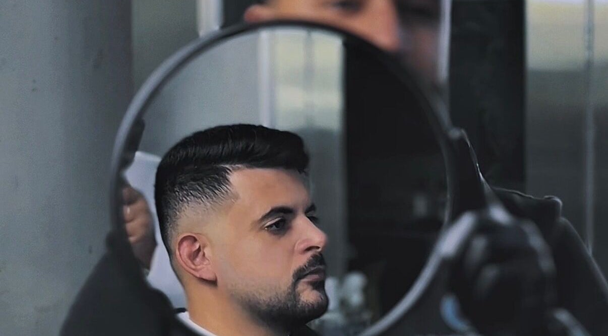Haircut reflection at Adam's Republic | Al-Shulah, Dammam, Eastern Province, SA in a round mirror.