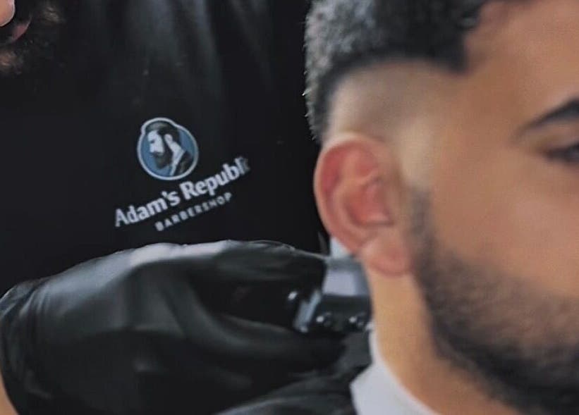 Barber at Adam's Republic | Al-Shati in Dammam, المنطقة الشرقية, SA skillfully trims a client's hair.